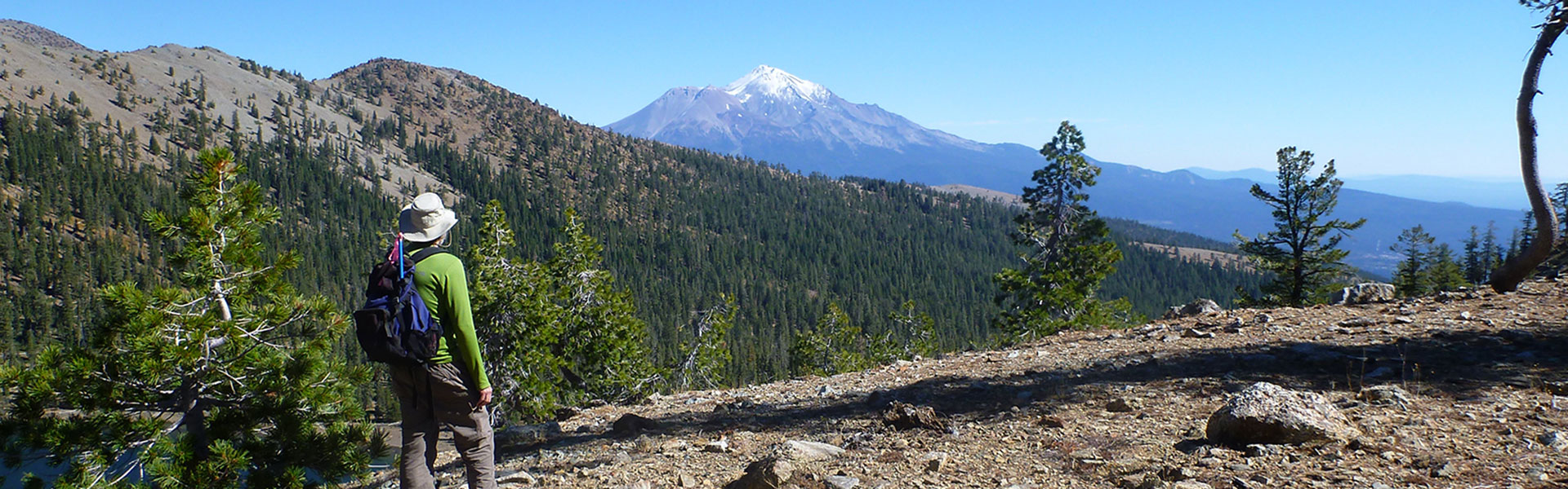 Guy looking at mountains in the background